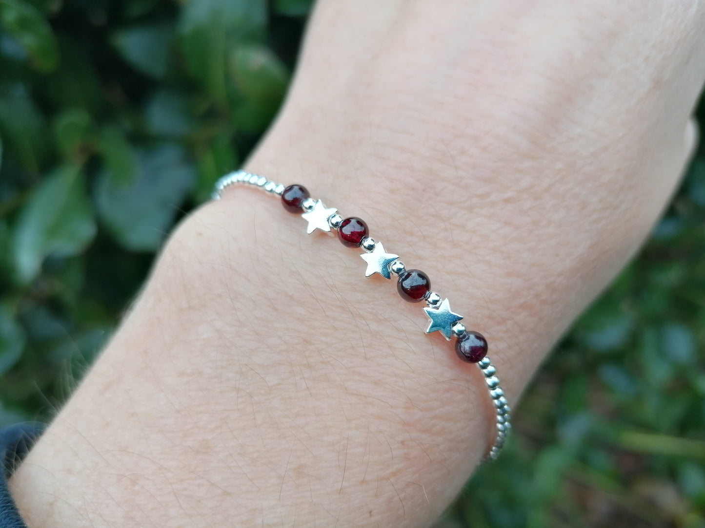Star bracelet with garnet gemstones. January birthstone.
