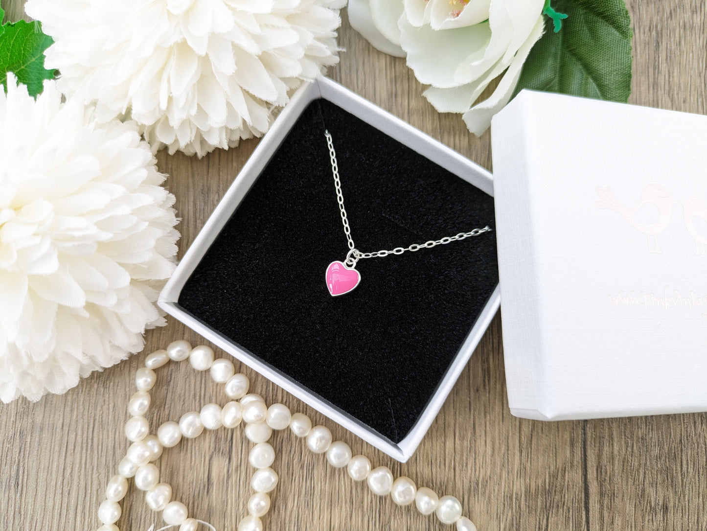 Pink heart charm necklace.