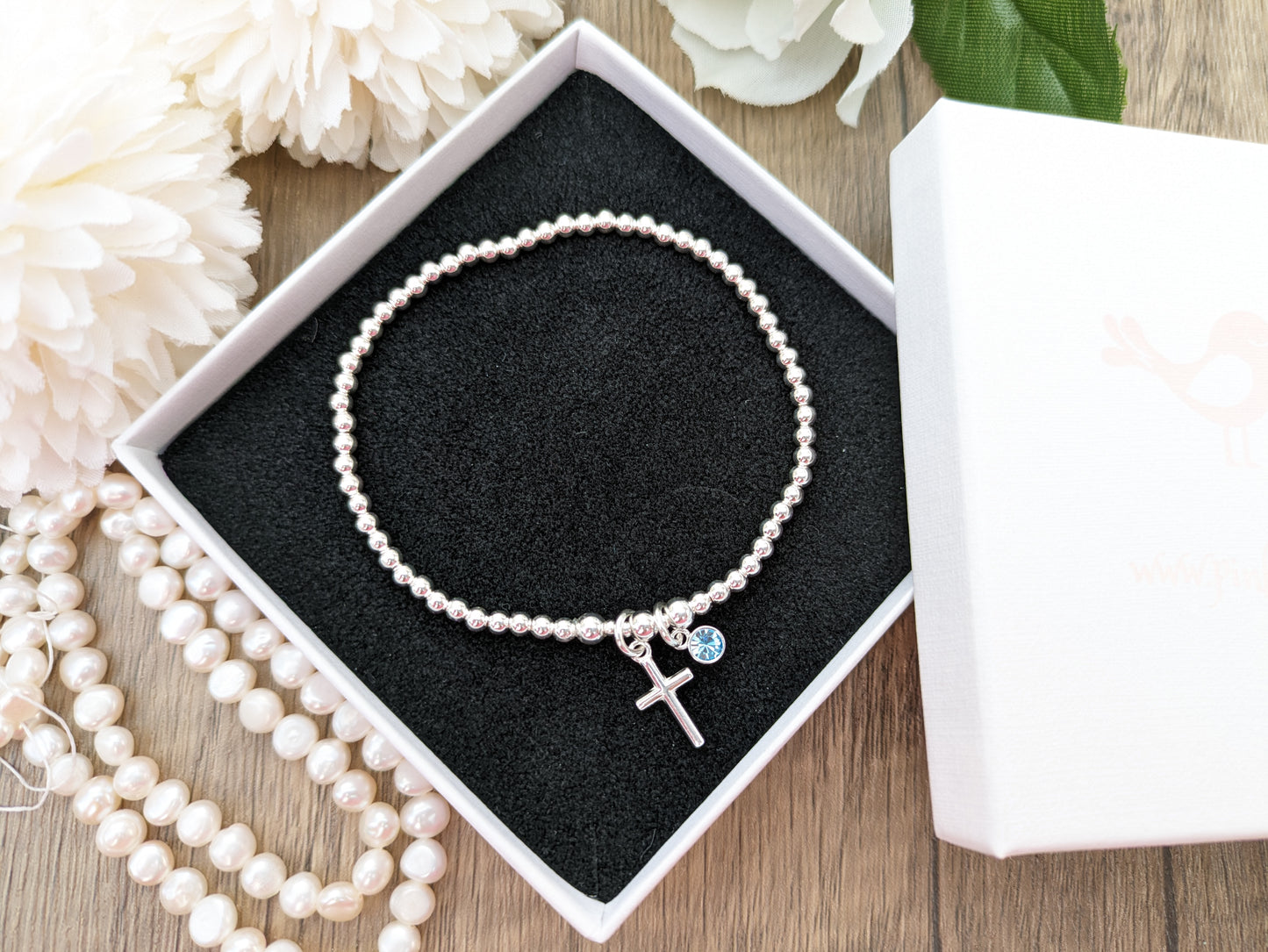 Cross bracelet with birthstone charm.