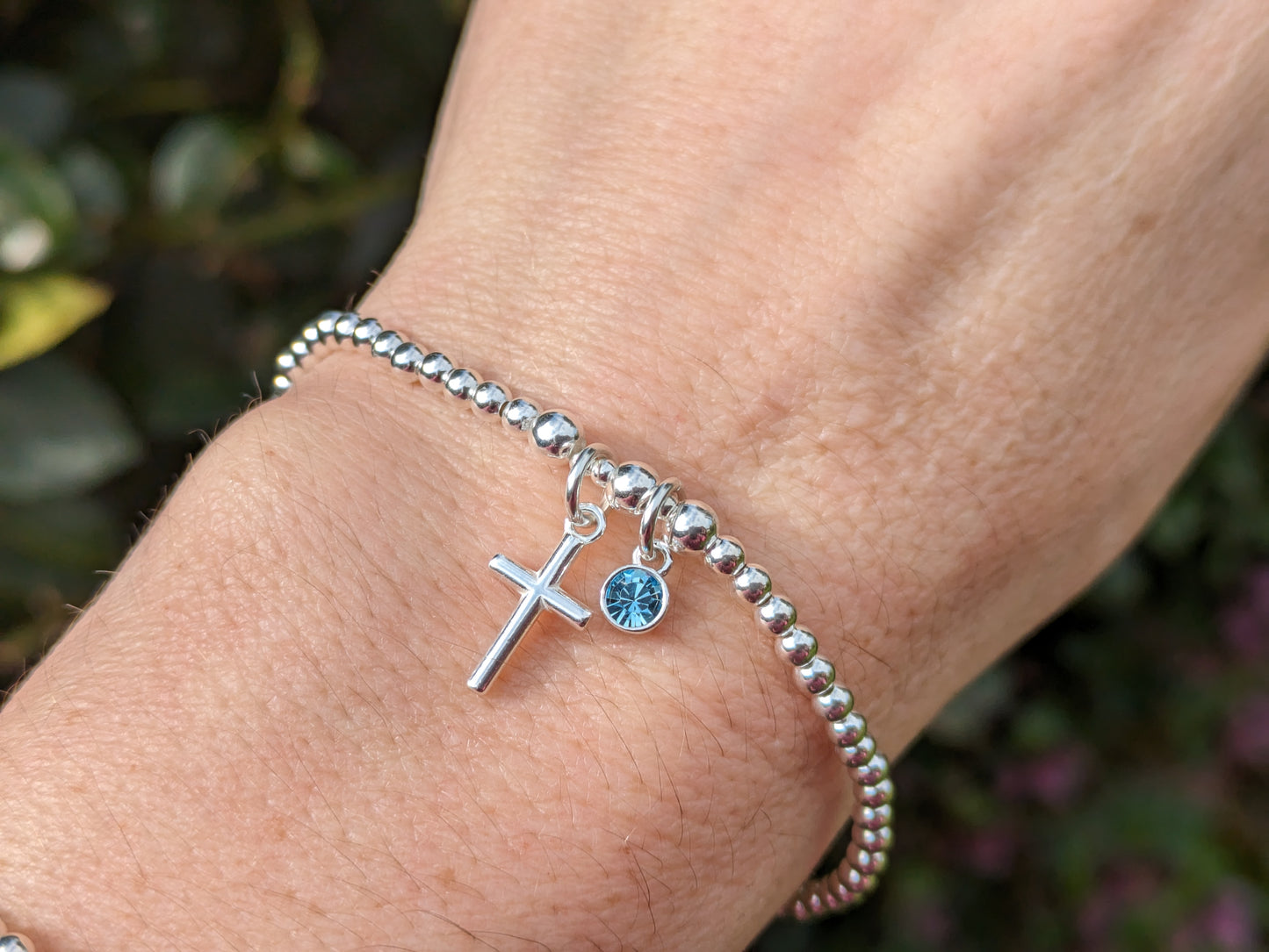 Cross and birthstone charm bracelet.