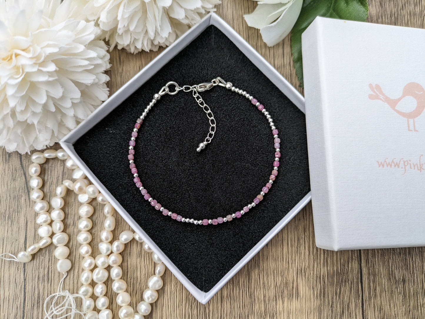 I love you morse code bracelet with ruby gemstones.