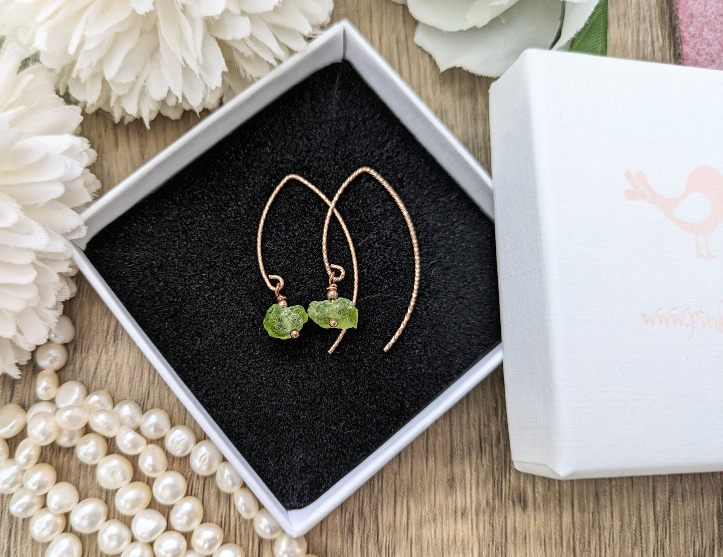 Raw peridot earrings in gold.