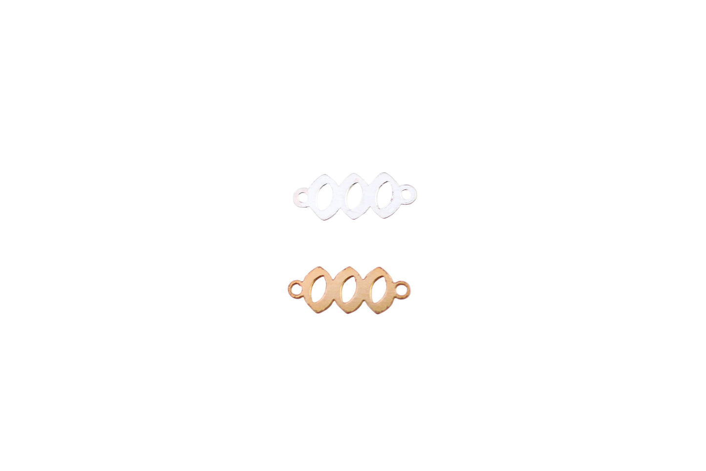 Two gold and one silver ring on a white marble surface
