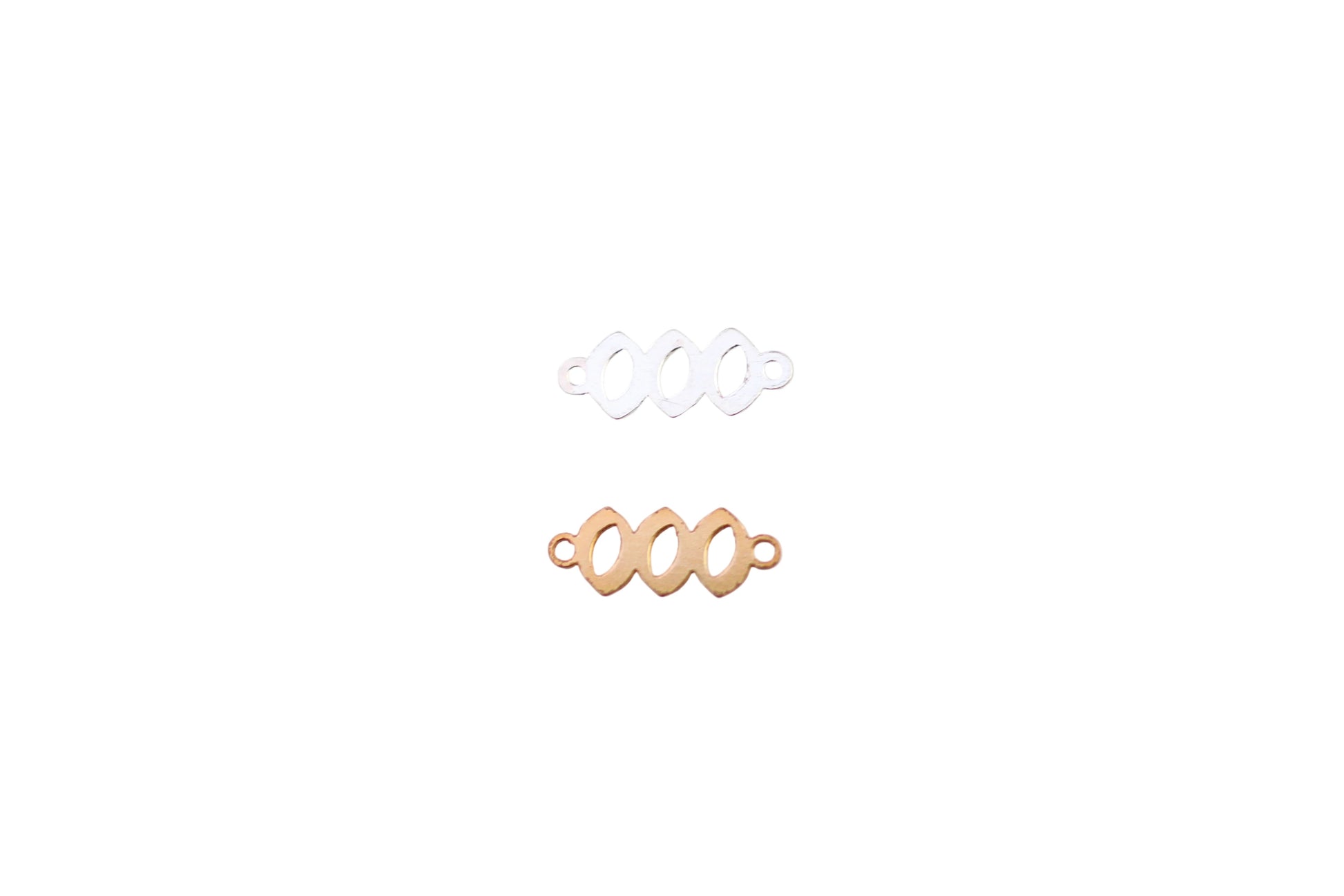 Two gold and one silver ring on a white marble surface