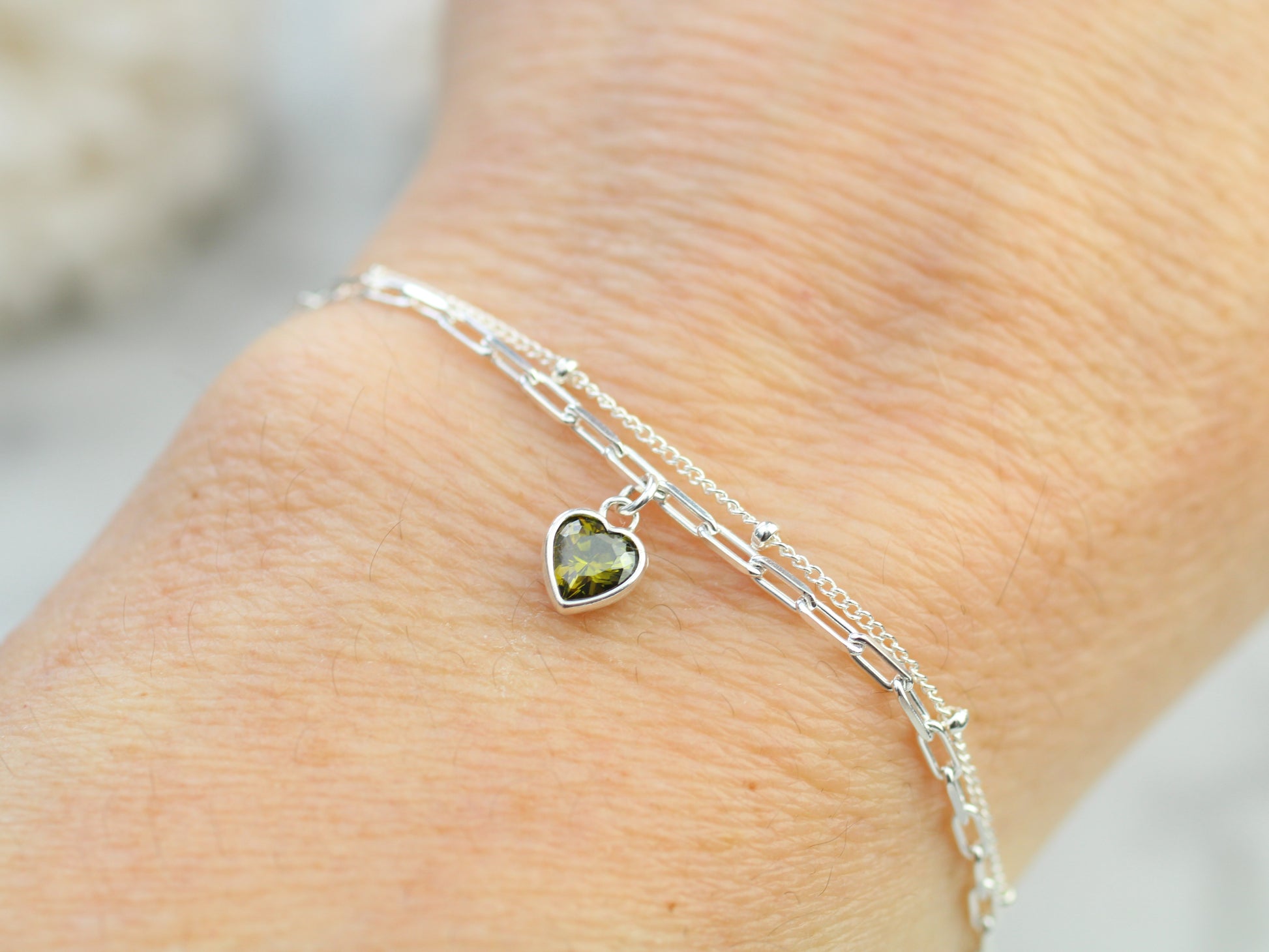 double chain bracelet with green heart charm