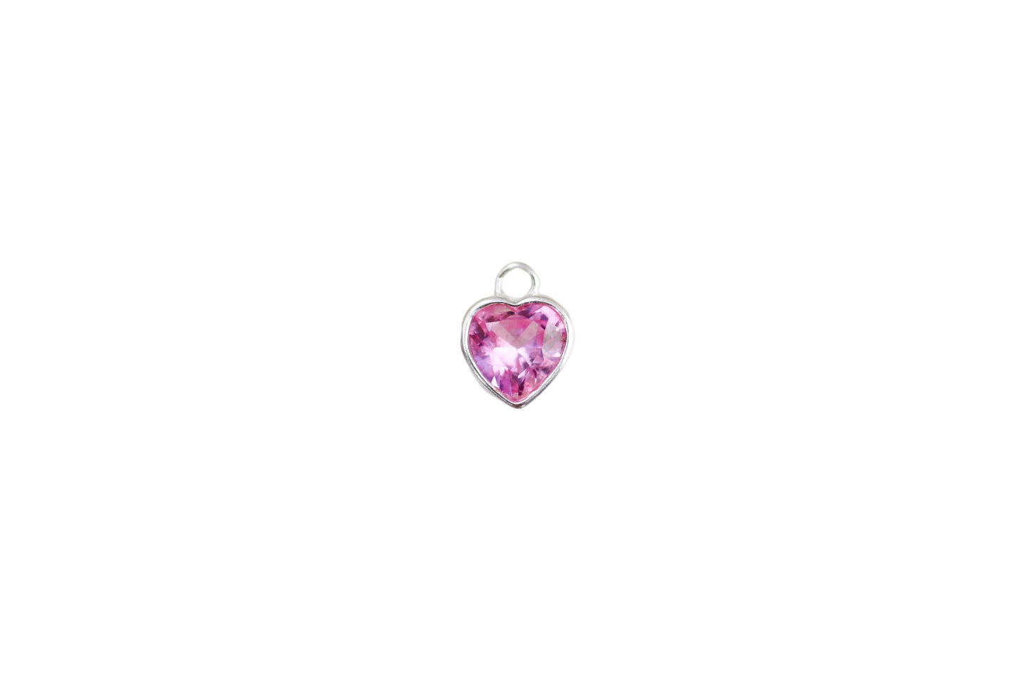 Heart-shaped pink gemstone on a marble background