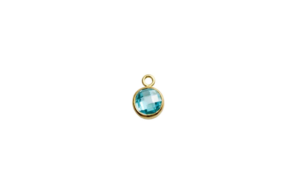 a blue charm on a white surface