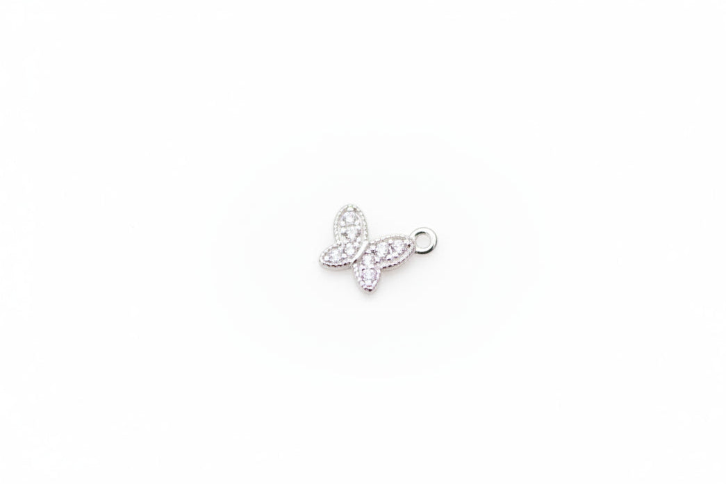Silver butterfly charm on a light gray background