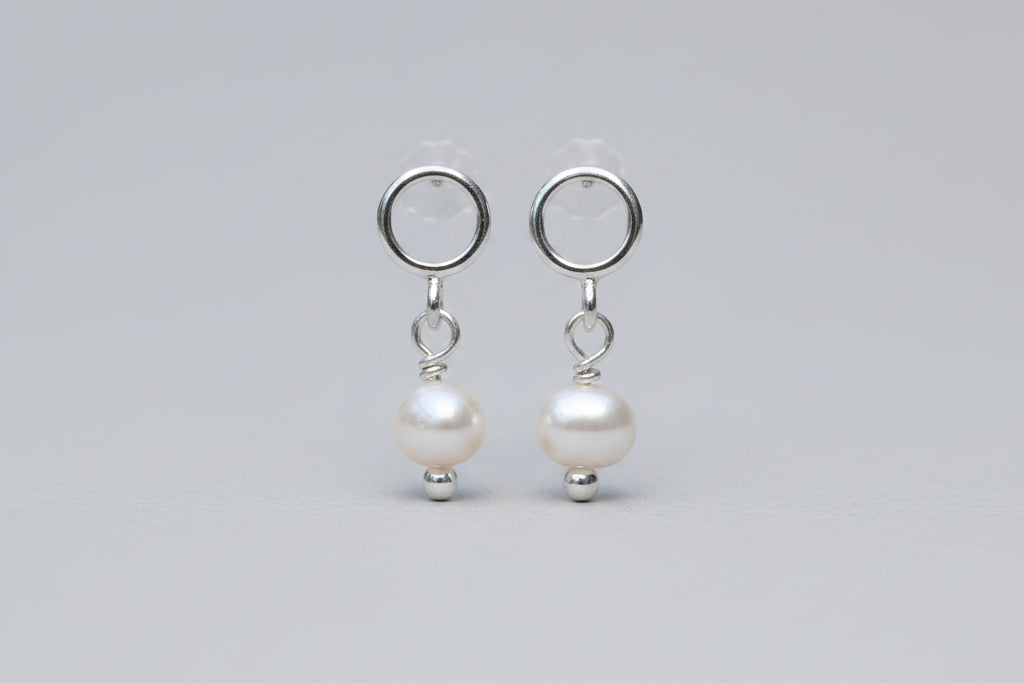 Pair of pearl earrings on a white background