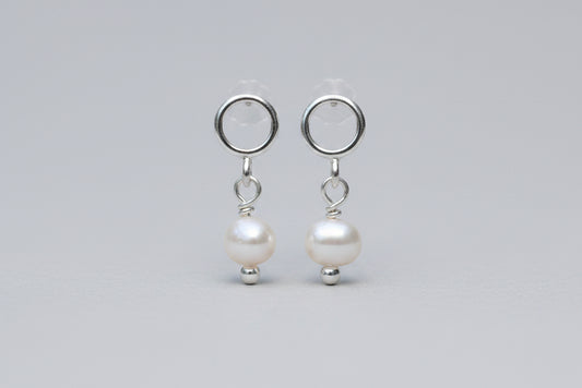 Pair of pearl earrings on a white background