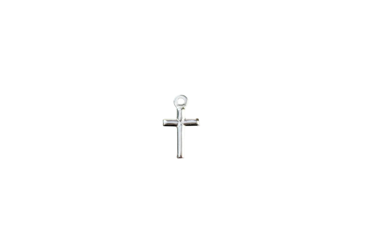 Silver cross pendant on a marble background