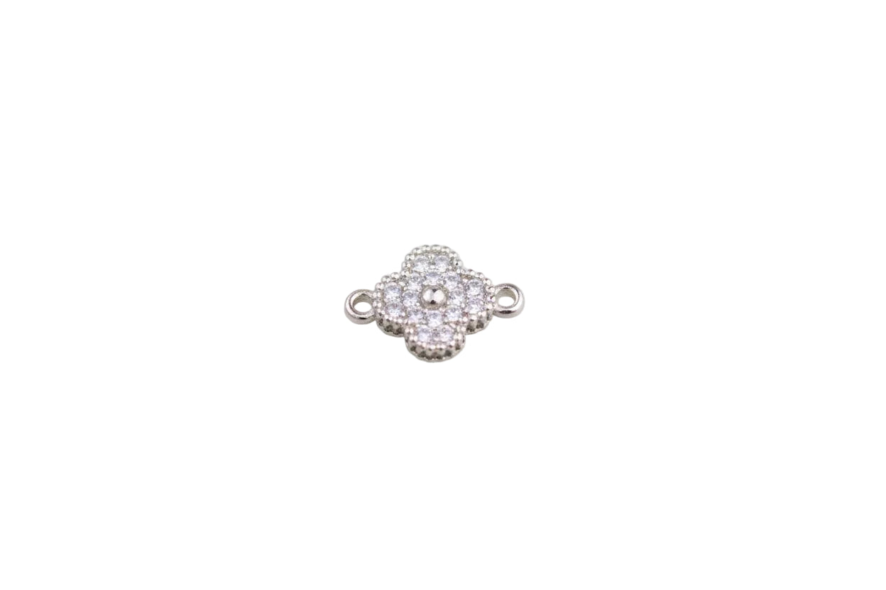 Silver floral jewelry connector on a light gray background