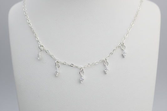 Silver necklace with small crystal marquis shaped on a white background