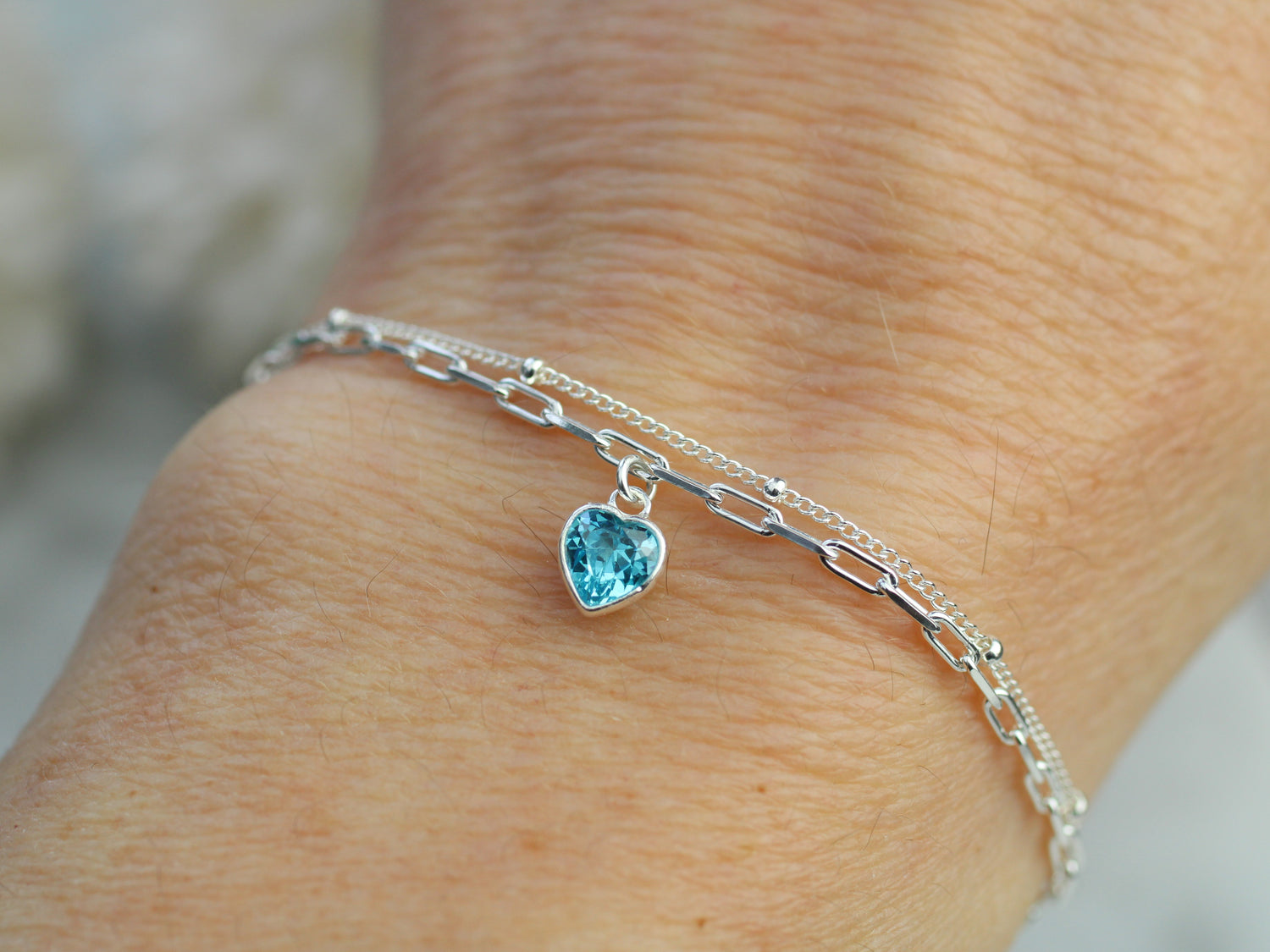 december crystal layered bracelet with a blue charm