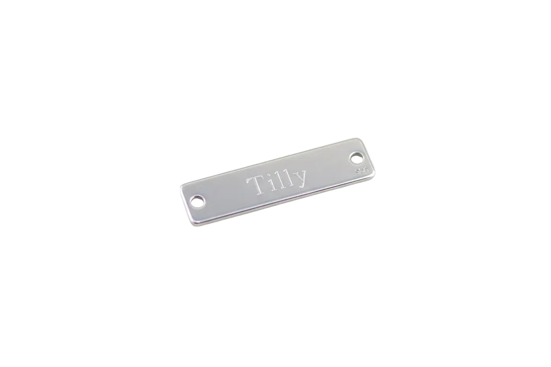 Silver nameplate with 'Tilly' engraved on a white background