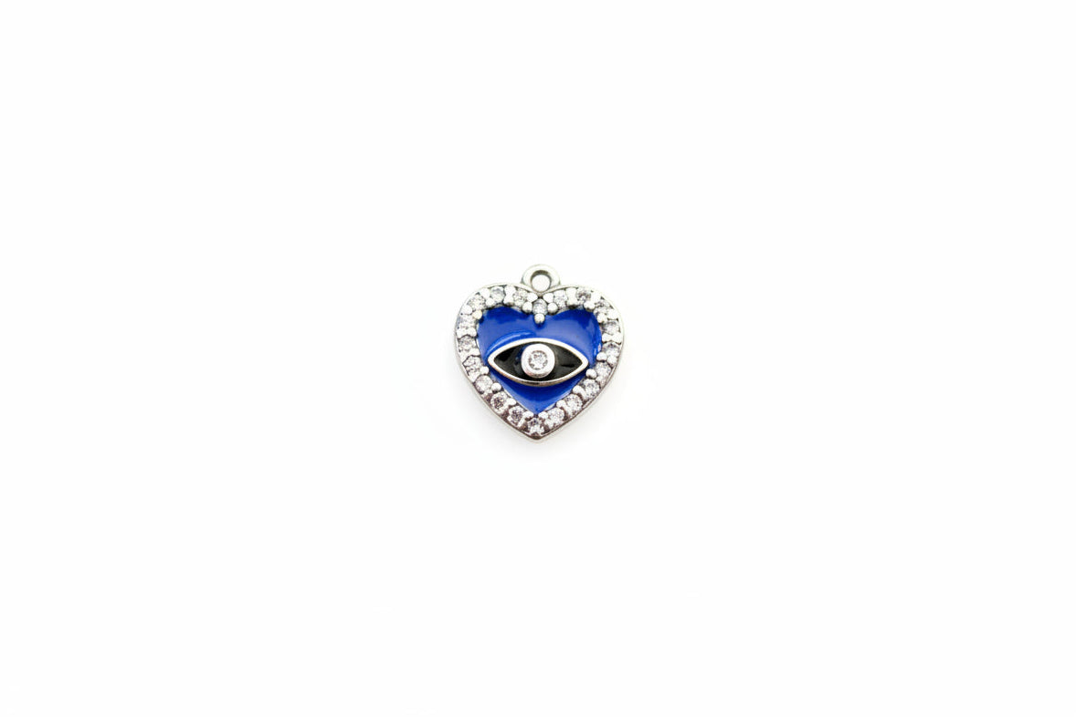Heart-shaped pendant with blue center and black eye on a marble background
