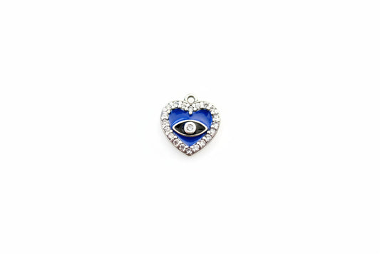 Heart-shaped pendant with blue center and black eye on a marble background