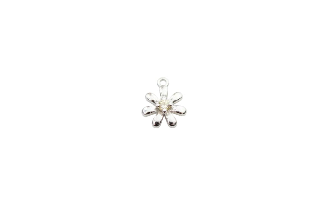 Silver flower charm on a marble surface