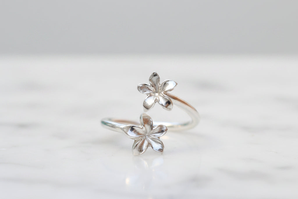 Silver flower-shaped ring on a light background