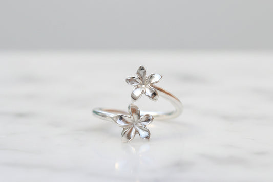 Silver flower-shaped ring on a light background