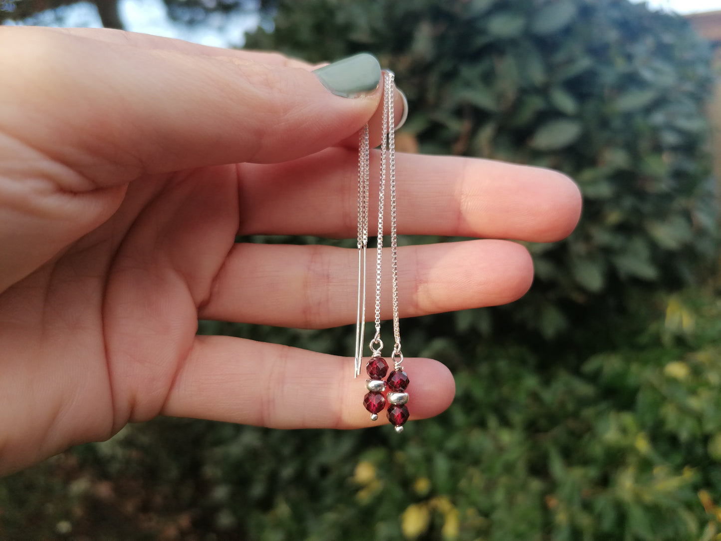 Garnet thread through earrings in sterling silver.