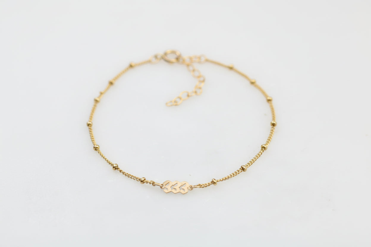 angel number anklet on a s=white background