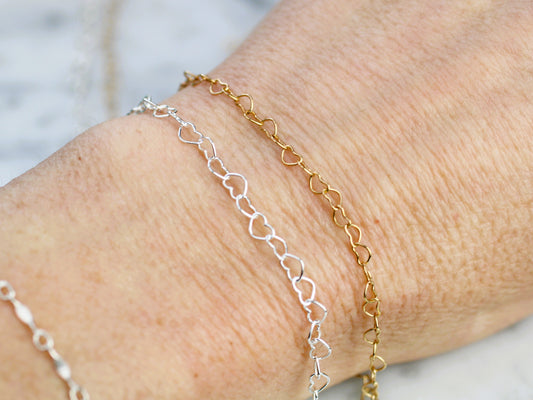 silver and gold chain on a wrist