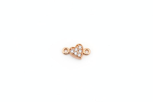 Gold heart-shaped jewelry clasp on a marble background