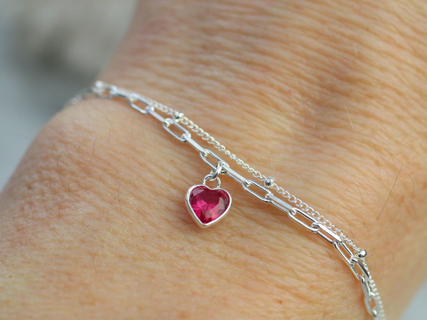 double chain bracelet with a red heart charm