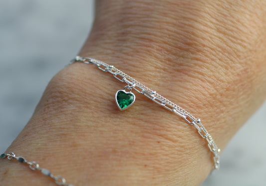 double layer chain with a heart charm worn on a wrist