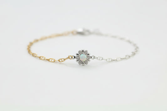 Bracelet with a floral design on a wrist against a neutral background