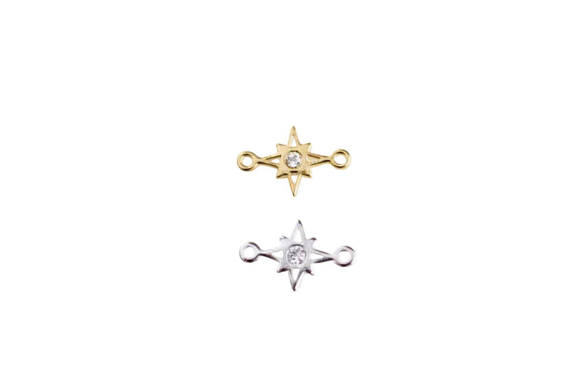 Two star-shaped earrings on a white surface