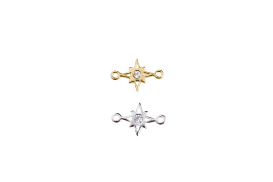 Two star-shaped earrings on a white surface