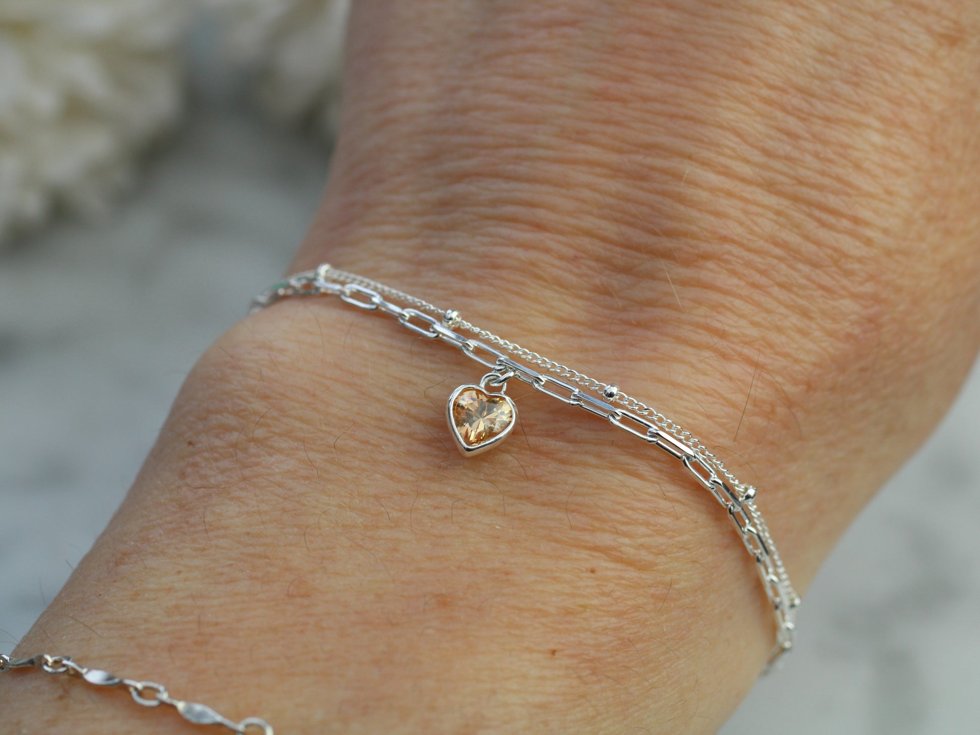 november crystal layered bracelet with a yellow heart charm