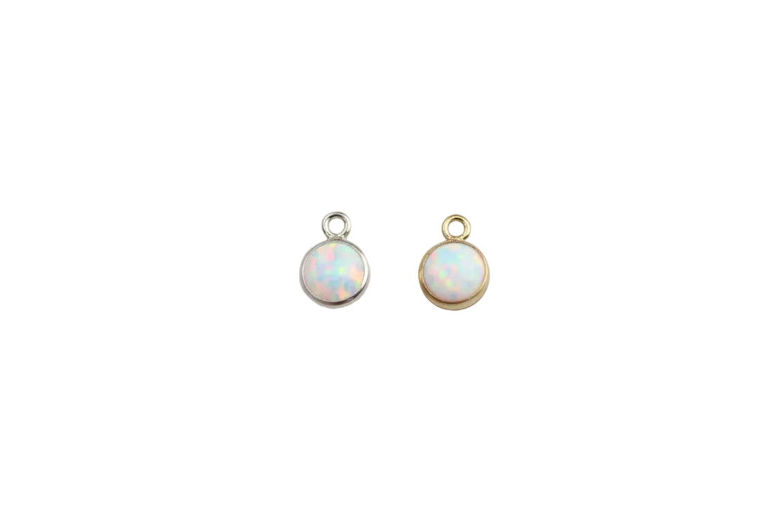 Two opal earrings on a light gray background