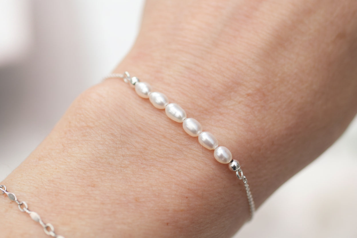 Pearl bracelet on a wrist with a blurred background