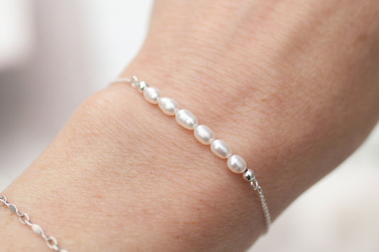 Pearl bracelet on a wrist with a blurred background