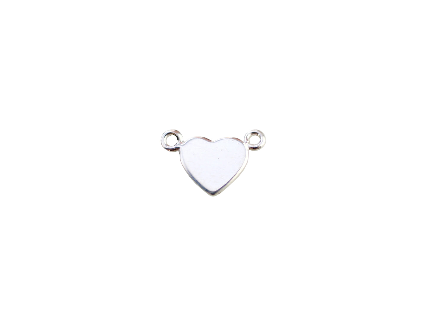 Silver heart-shaped pendant on a marble background