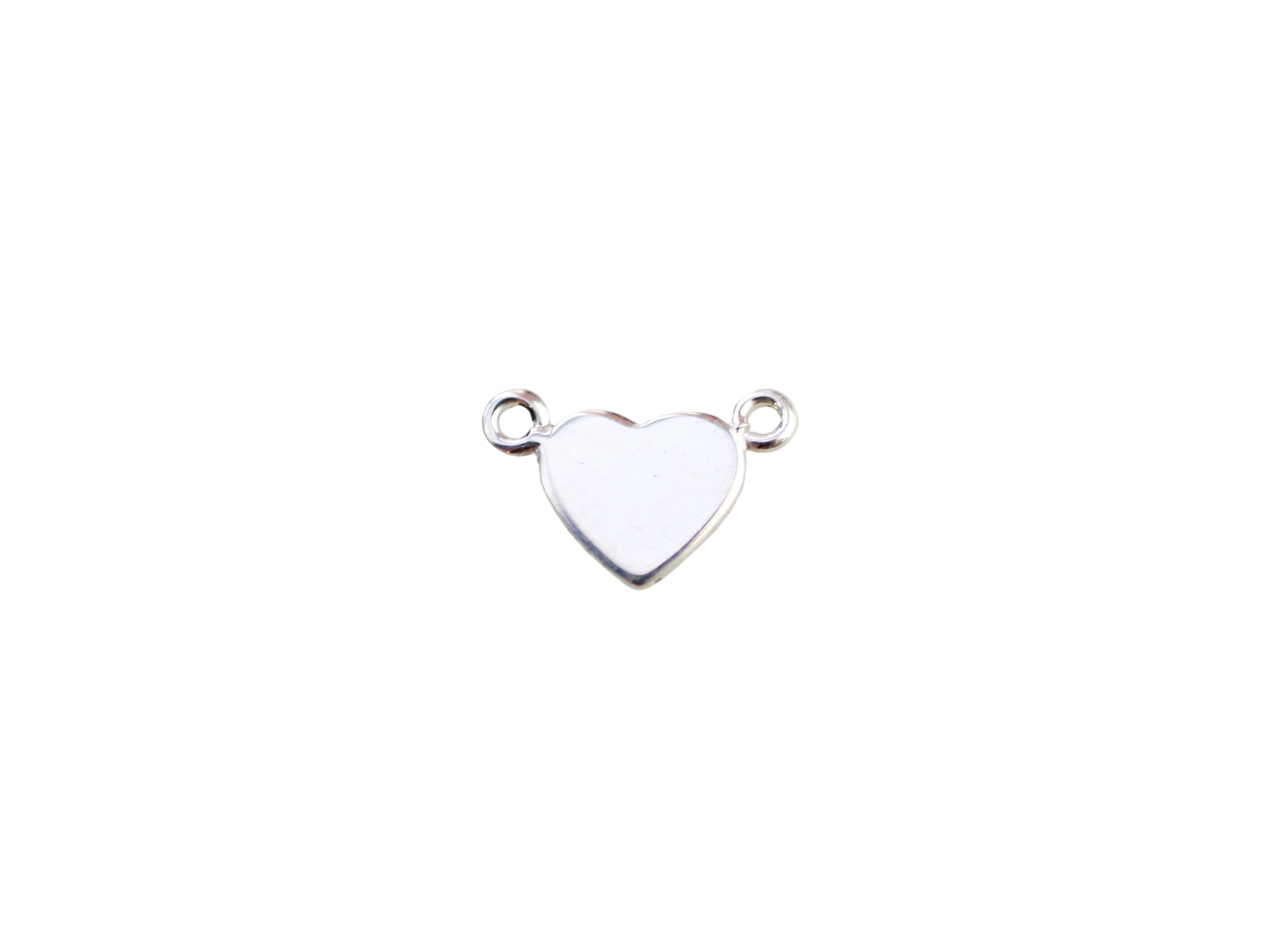 Silver heart-shaped pendant on a marble background