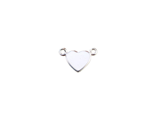 Silver heart-shaped pendant on a marble background