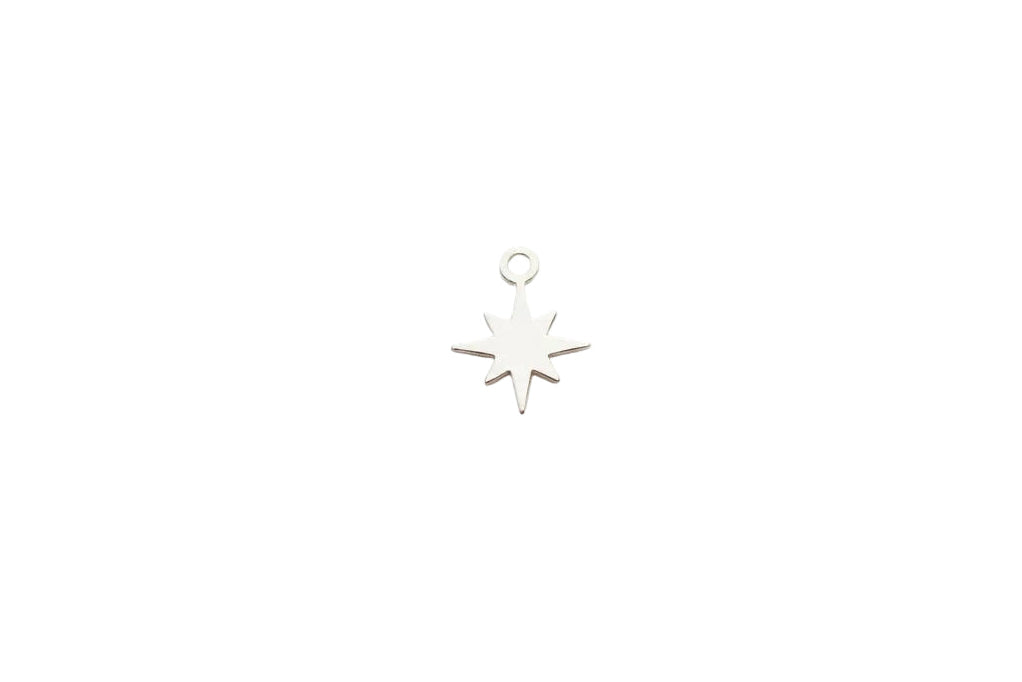 Silver star-shaped pendant on a white marble background