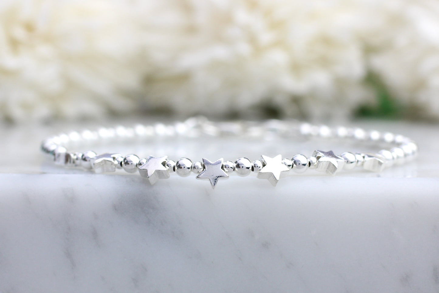 star bracelet on a marble surface