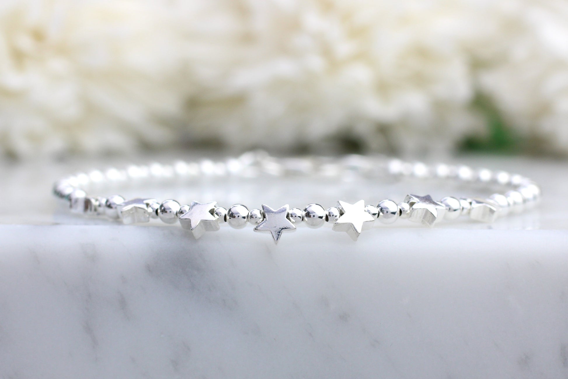 star bracelet on a marble surface