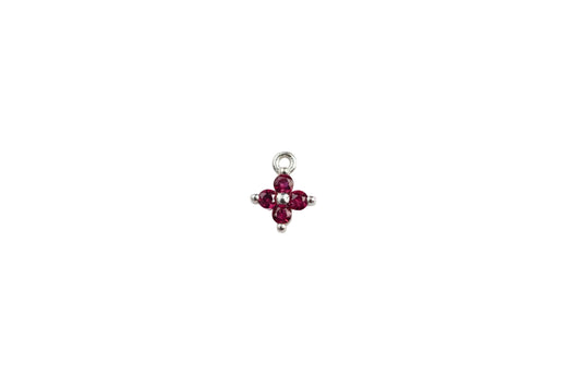 pink flower charm on a white surface