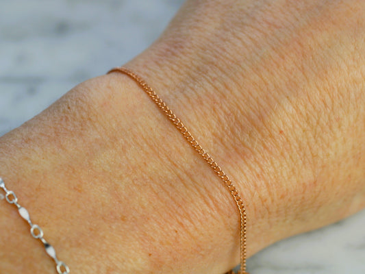 rose gold chain on a wrist