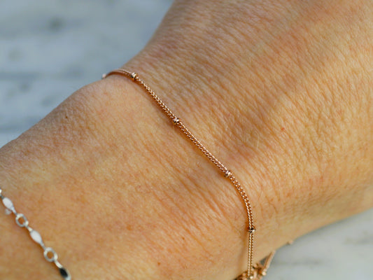 rose gold chain on a wrist