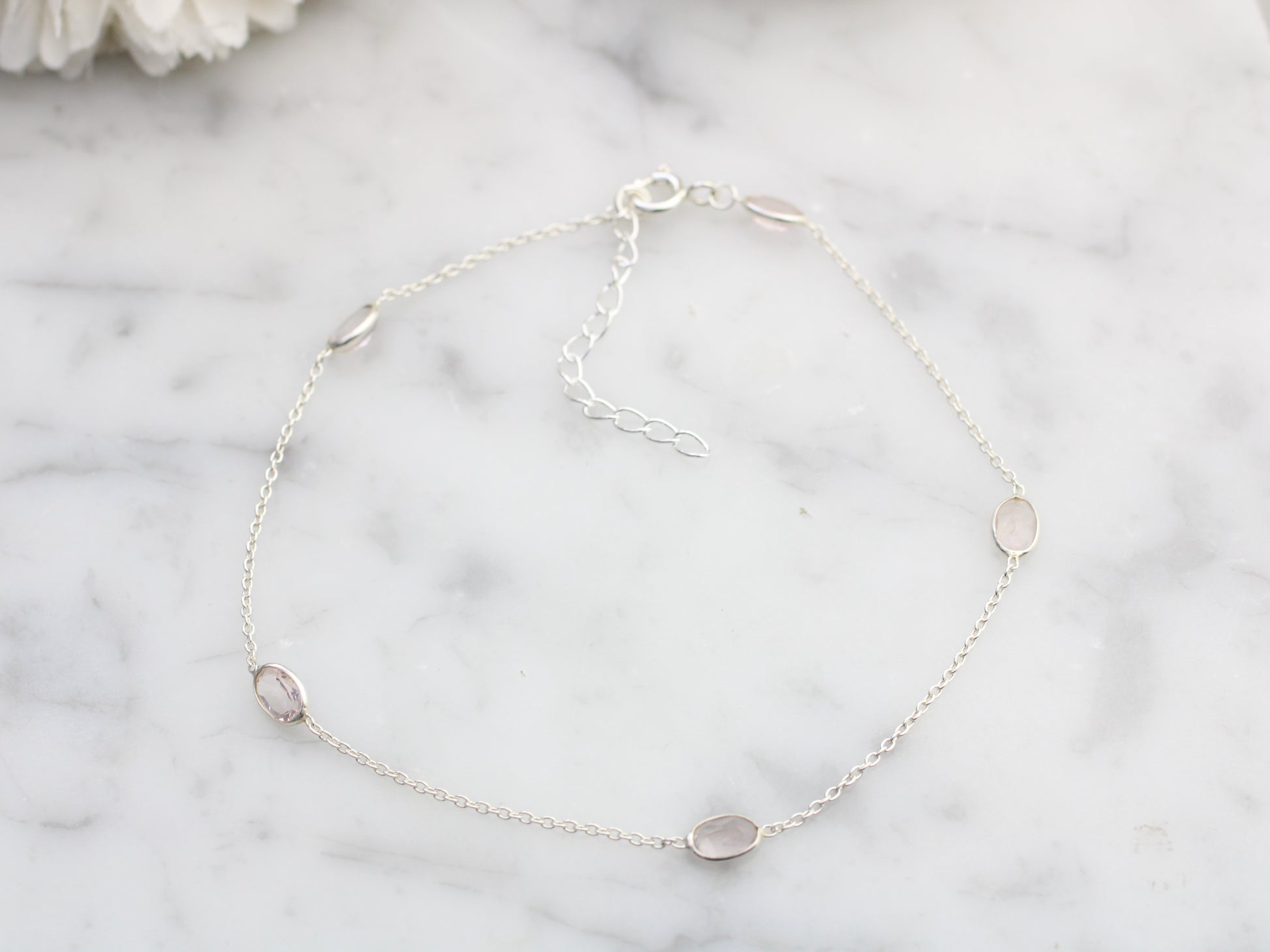 rose quartz anklet on a white background