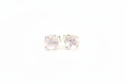 pink gemstone earrings on a white surface