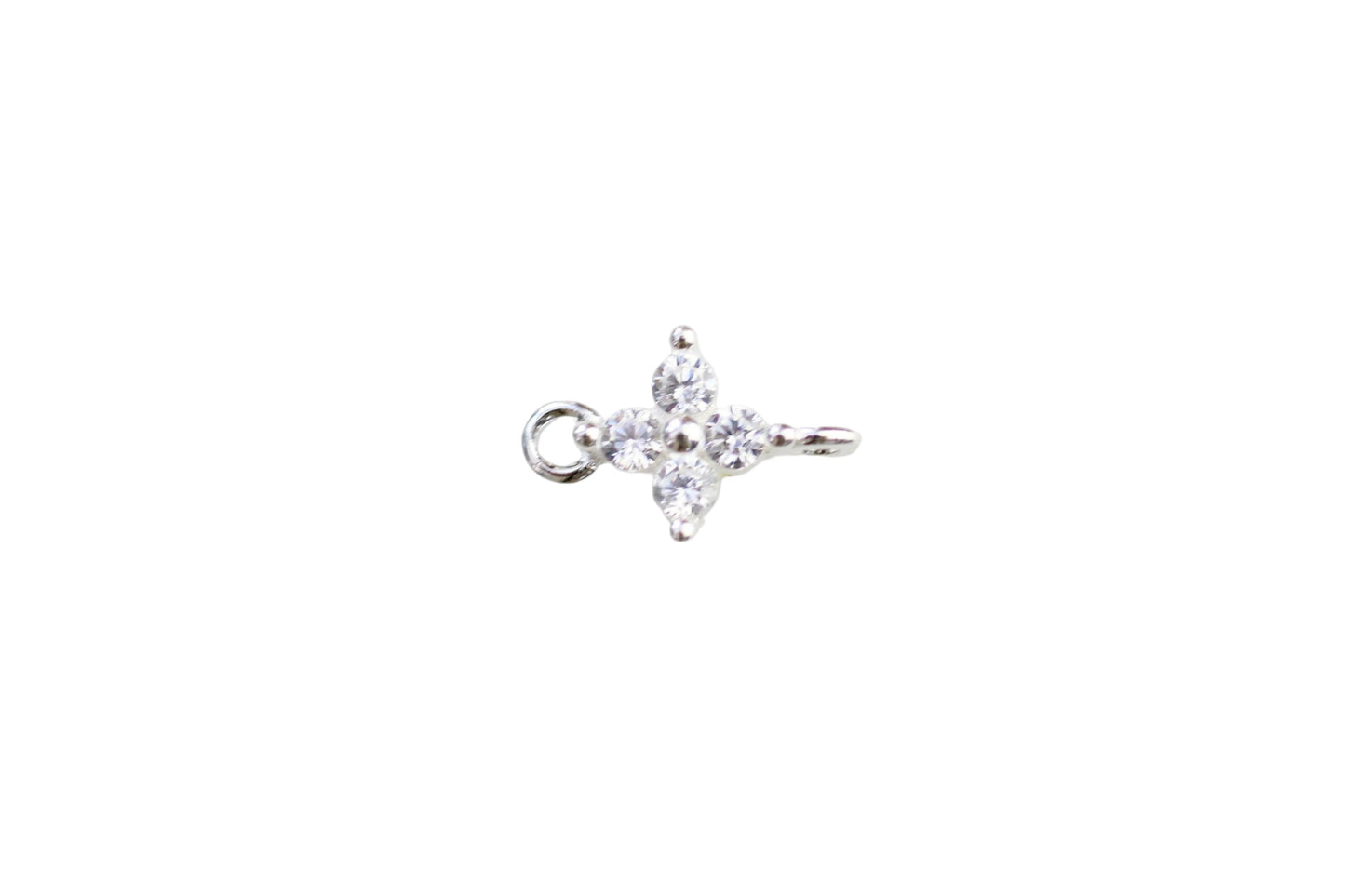 Silver ring with a star-shaped diamond on a light marble background