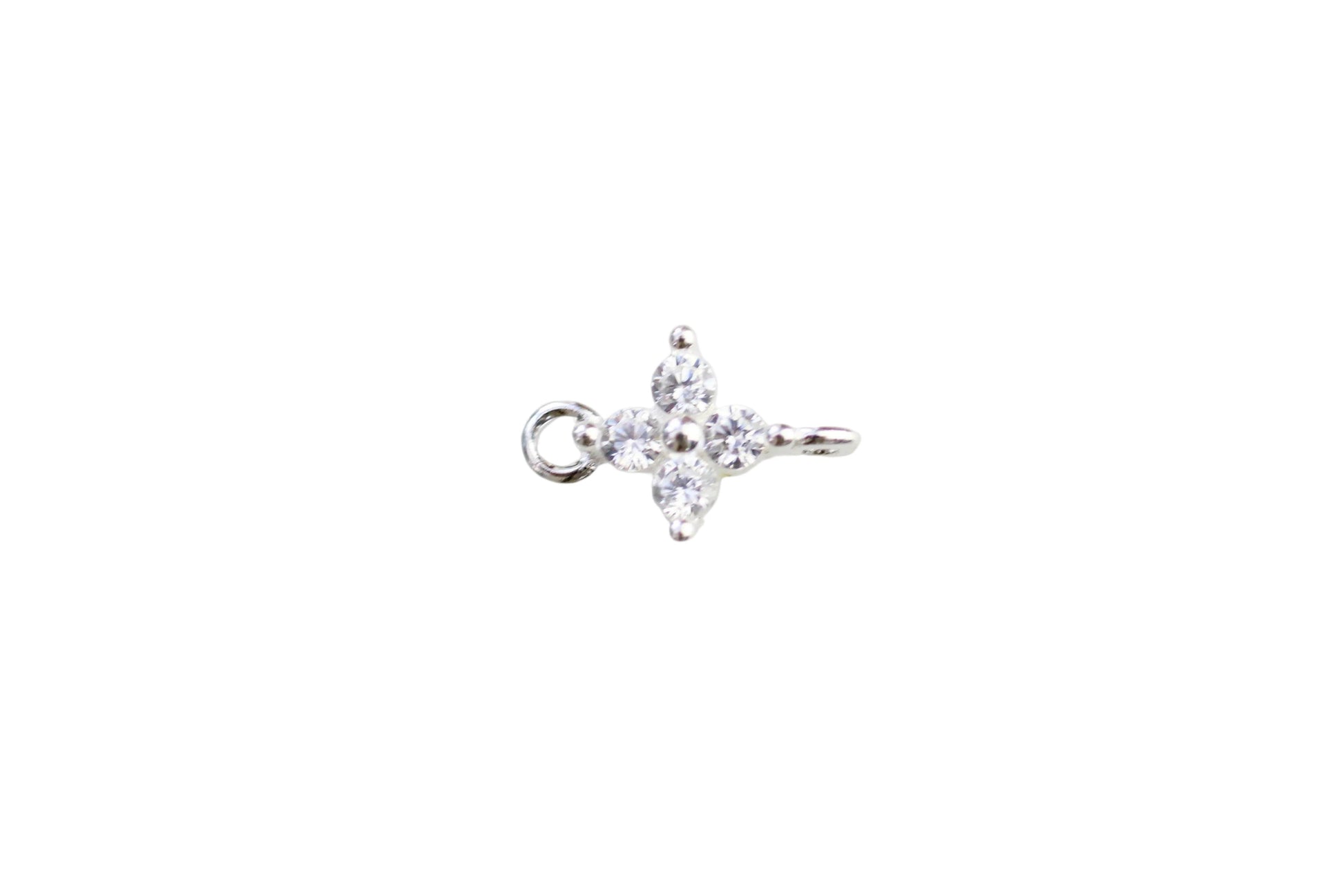 Silver ring with a star-shaped diamond on a light marble background